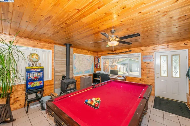 a room with pool table windows and a table