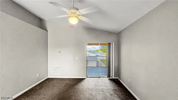 an empty room with closet and windows
