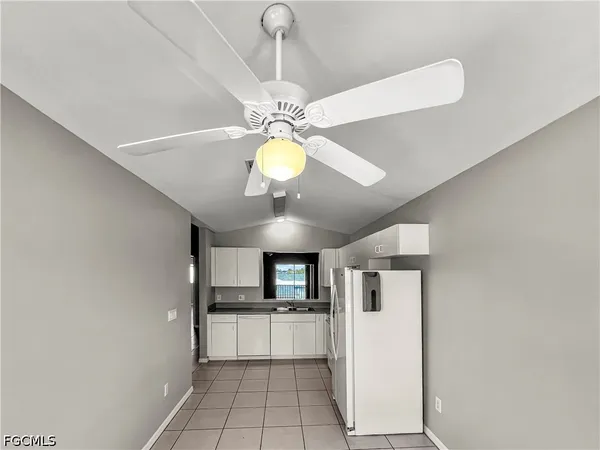 a view of a kitchen with a sink and stainless steel appliances