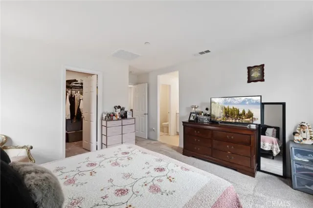 a bedroom with a bed and a dresser in it