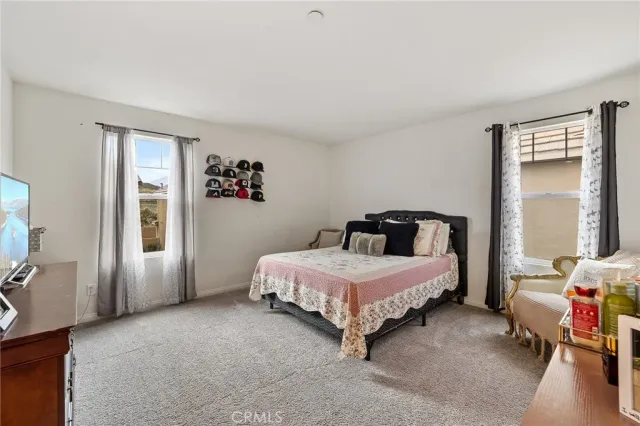 a spacious bedroom with a bed and a couch