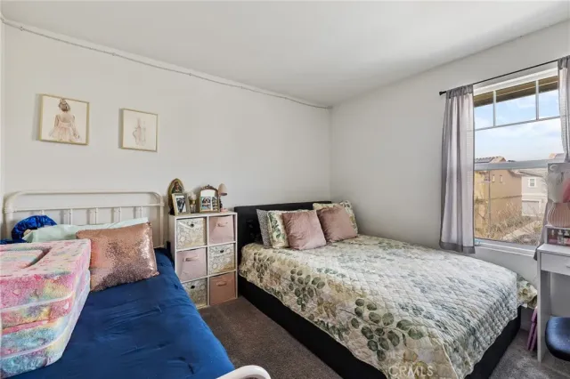 a bed room with a bed and a large window