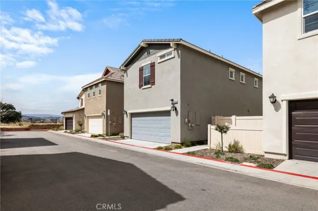 a front view of a house with a road
