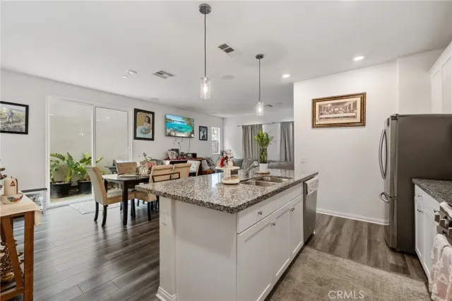 a open kitchen with stainless steel appliances granite countertop a stove and a refrigerator
