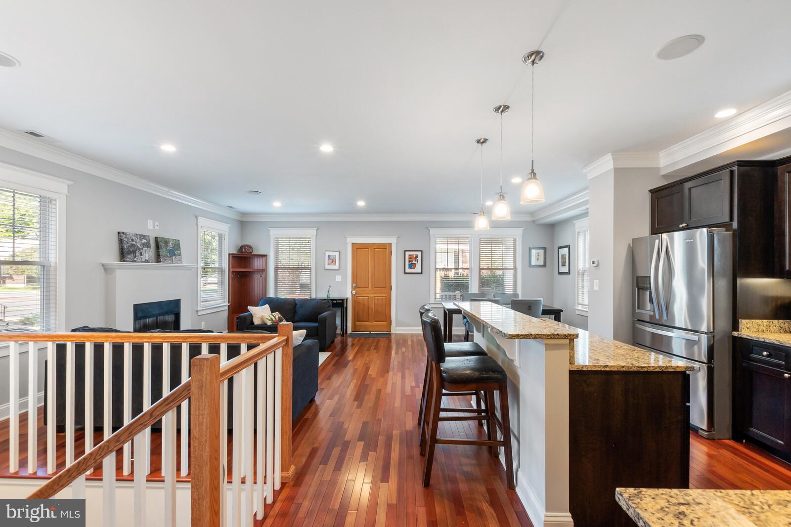 23 East Braddock Road Alexandria, VA 22301 - Photo 13 of 29 a kitchen with stainless steel appliances kitchen island granite countertop a refrigerator a stove top oven a dining table and chairs with wooden floor