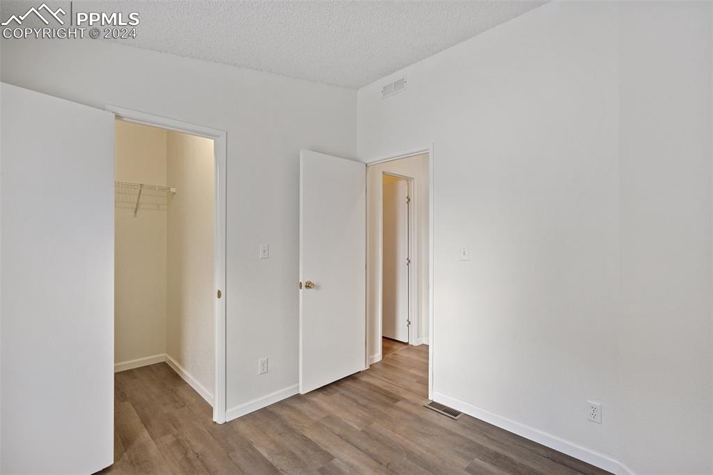 16625 Roller Coaster Road Colorado Springs, CO 80921 - Photo 13 of 44 a view of an empty room with wooden floor