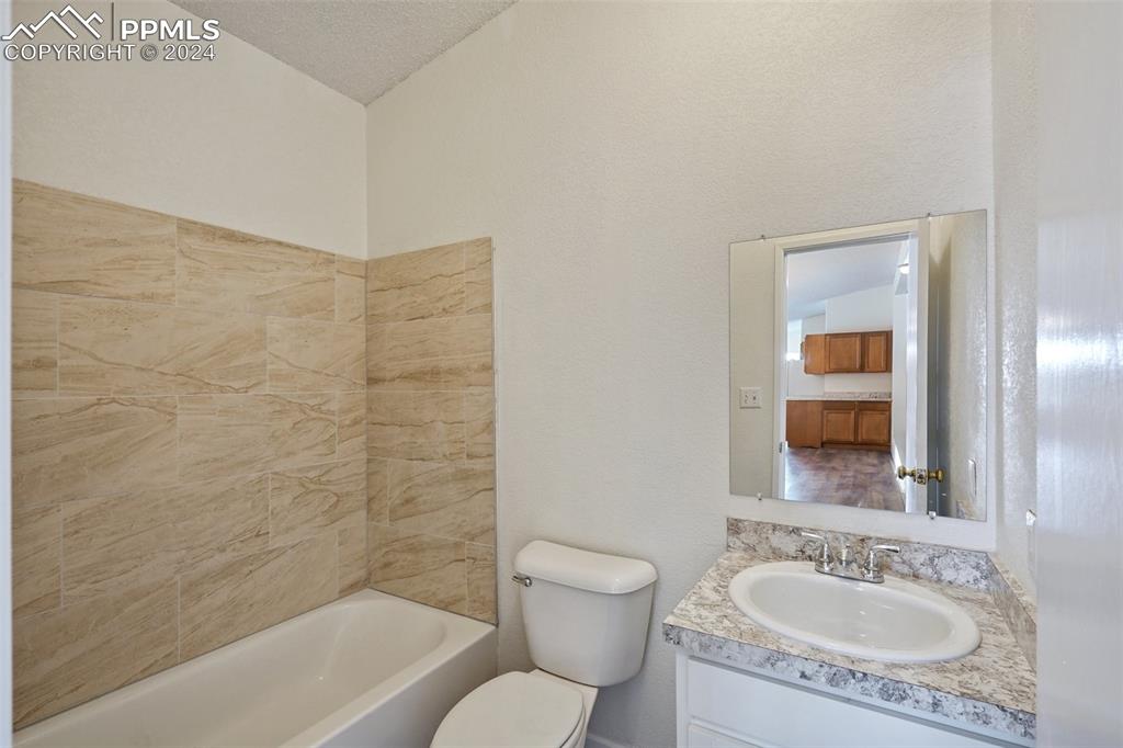 16625 Roller Coaster Road Colorado Springs, CO 80921 - Photo 14 of 44 a bathroom with a granite countertop sink toilet and shower