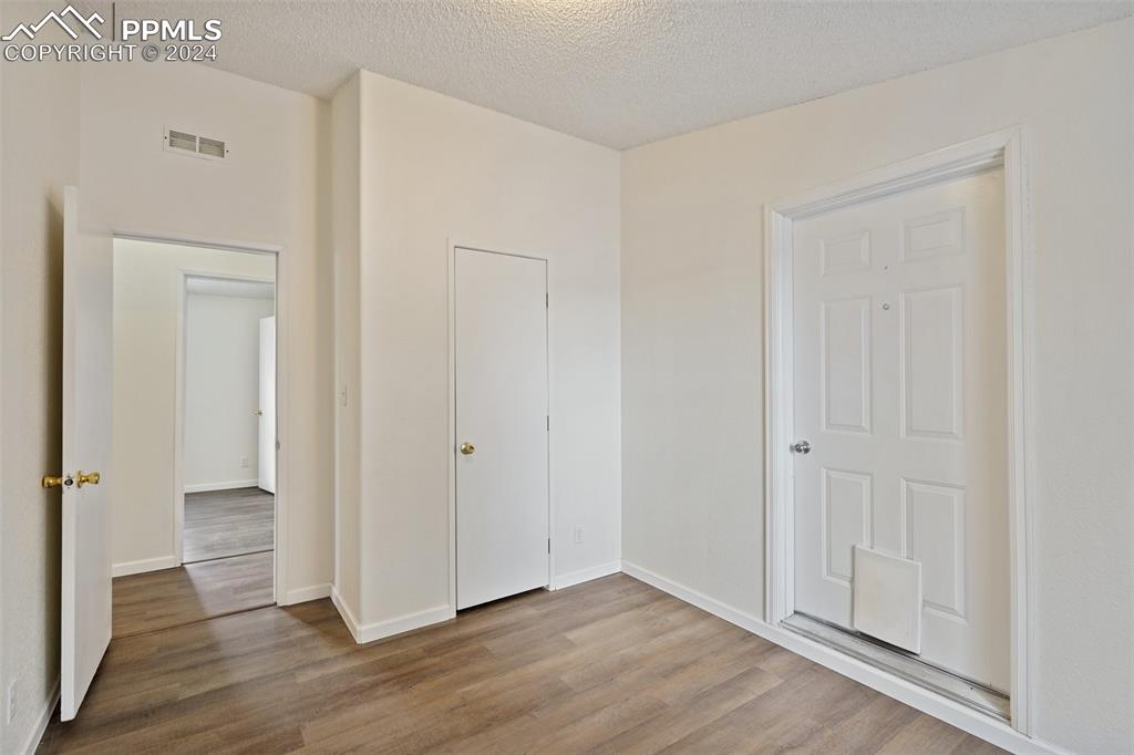 16625 Roller Coaster Road Colorado Springs, CO 80921 - Photo 15 of 44 an empty room with wooden floor