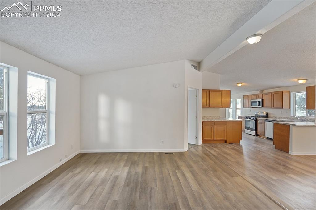 16625 Roller Coaster Road Colorado Springs, CO 80921 - Photo 18 of 44 a view of kitchen with furniture and wooden floor