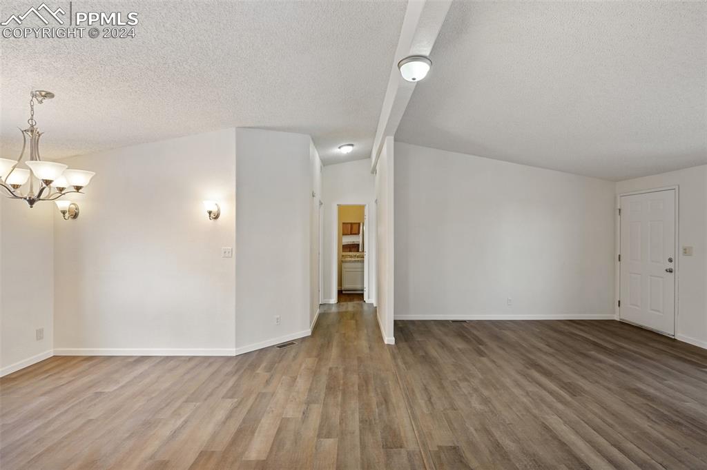 16625 Roller Coaster Road Colorado Springs, CO 80921 - Photo 20 of 44 a view of empty room with wooden floor