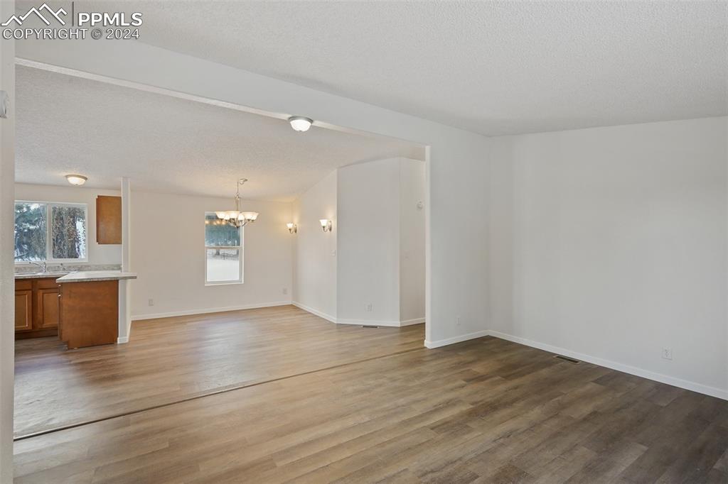 16625 Roller Coaster Road Colorado Springs, CO 80921 - Photo 21 of 44 wooden floor in an empty room with a window