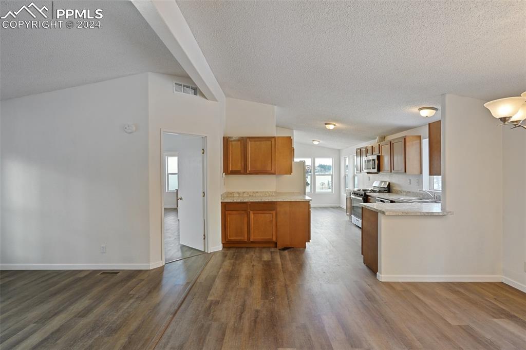 16625 Roller Coaster Road Colorado Springs, CO 80921 - Photo 25 of 44 a kitchen with a refrigerator and a stove top oven