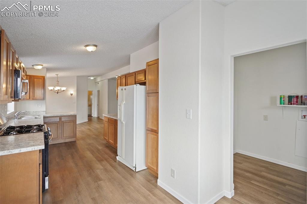 16625 Roller Coaster Road Colorado Springs, CO 80921 - Photo 28 of 44 a view of a kitchen with furniture and wooden floor