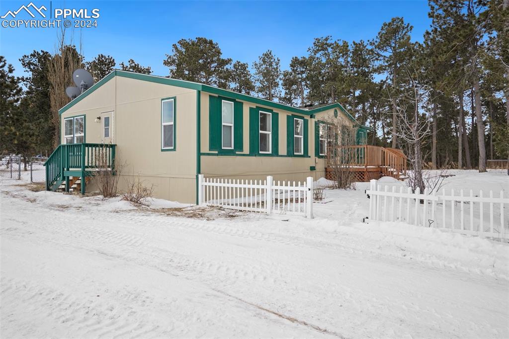 16625 Roller Coaster Road Colorado Springs, CO 80921 - Photo 42 of 44 a view of white house with a yard