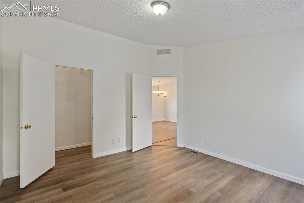 16625 Roller Coaster Road Colorado Springs, CO 80921 - Photo 9 of 44 a view of an empty room and wooden floor