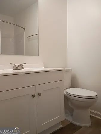 a bathroom with a sink toilet and mirror