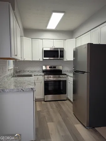 a kitchen with a refrigerator stove and microwave