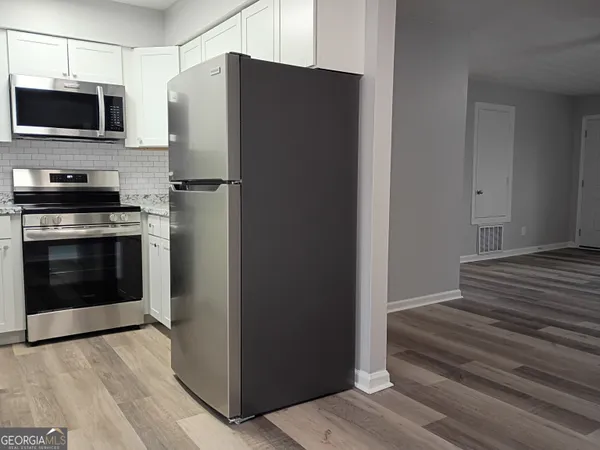 a kitchen with a refrigerator stove and microwave