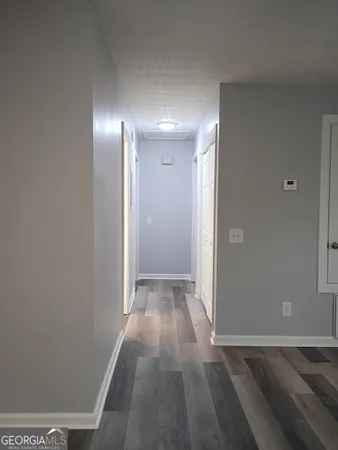 a view of hallway with wooden floor