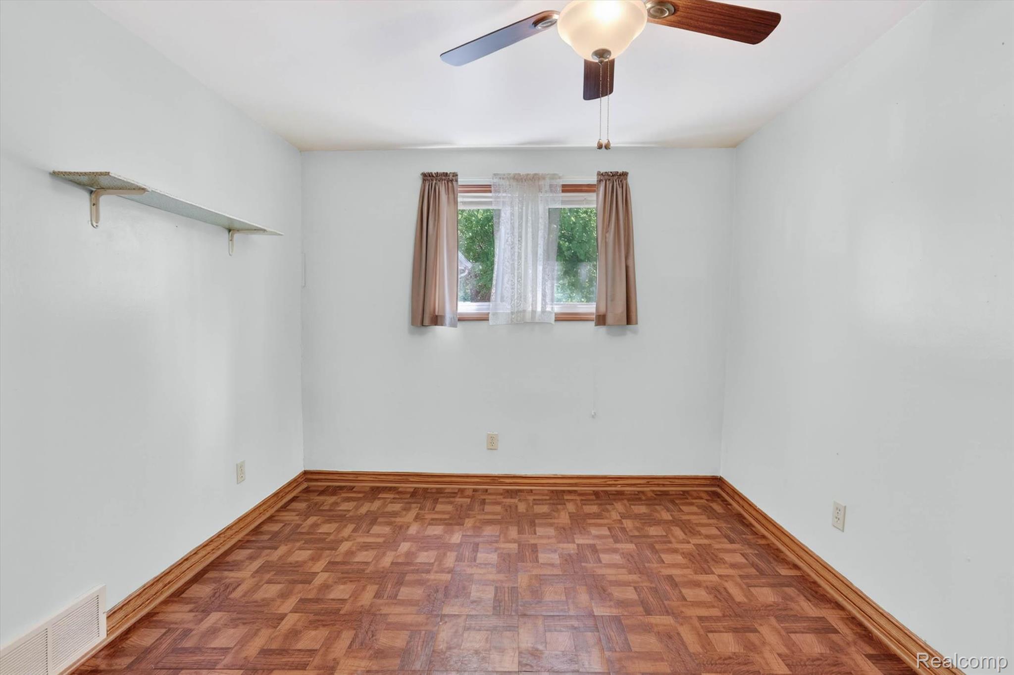 7974 West Gilford Road Reese, MI 48757 - Photo 20 of 36 Spare room featuring parquet floors and a ceiling fan
