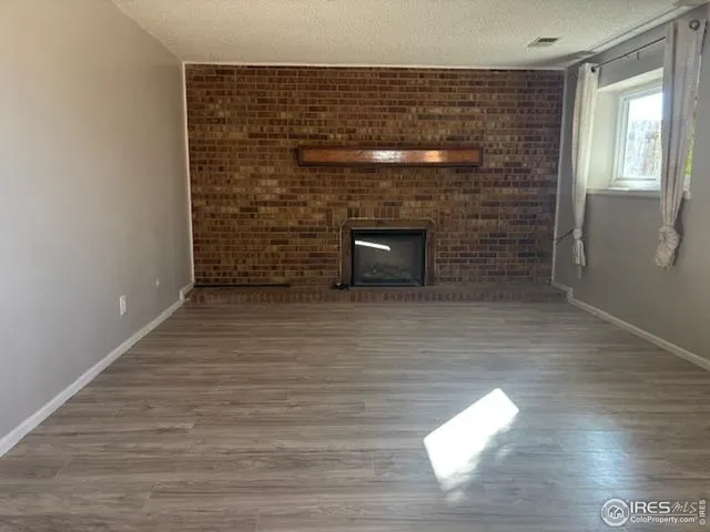 a view of empty room with a fireplace