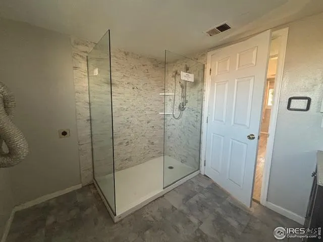 a bathroom with a shower and toilet