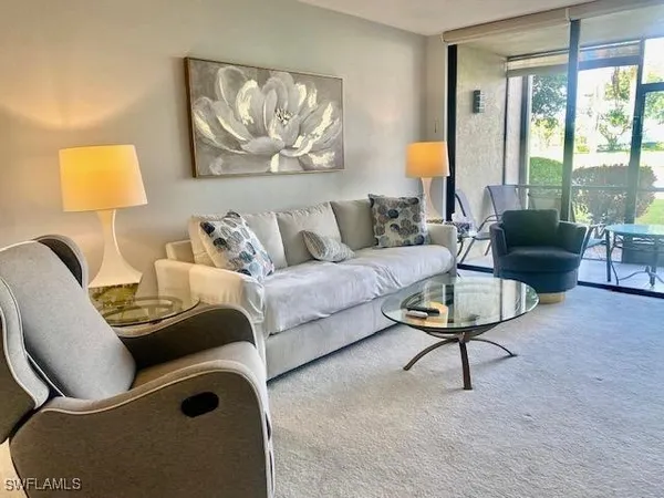 a living room with furniture and a lamp