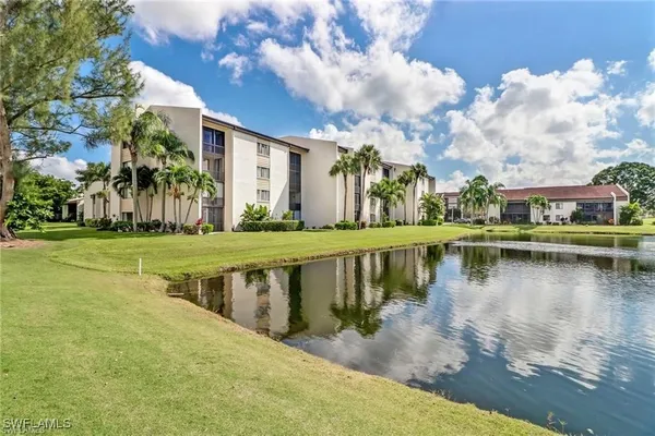 a view of a lake with a house in the background