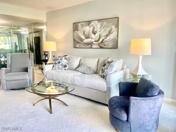 a living room with furniture and a painting