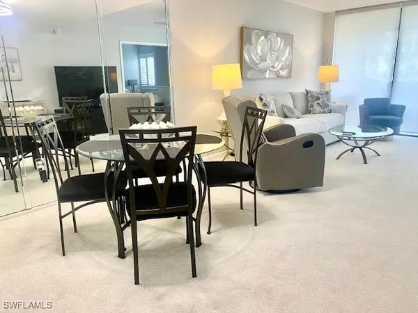 a living room with furniture a flat screen tv and a table