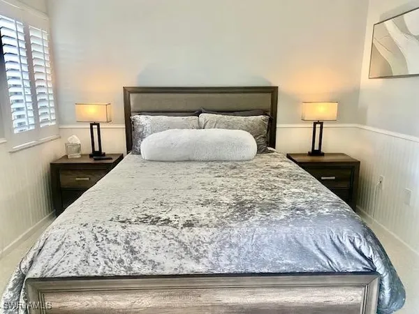 a bedroom with a bed and a night stand