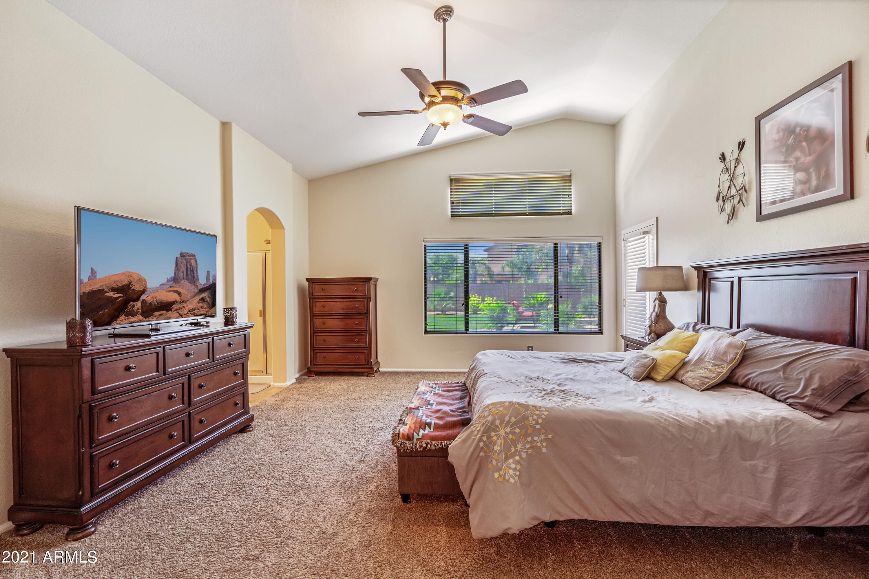 28726 North Nobel Road Phoenix, AZ 85085 - Photo 10 of 14 a bedroom with a bed and a chandelier