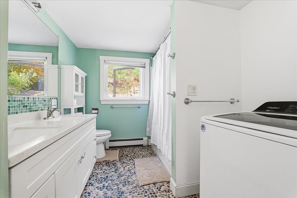 179 Hedges Pond Road Plymouth, MA 02360 - Photo 12 of 18 a bathroom with a sink toilet and window