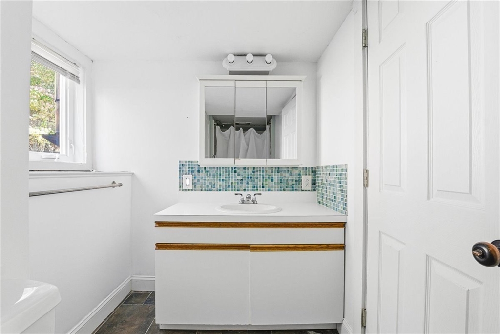 179 Hedges Pond Road Plymouth, MA 02360 - Photo 17 of 18 a bathroom with a sink and a mirror