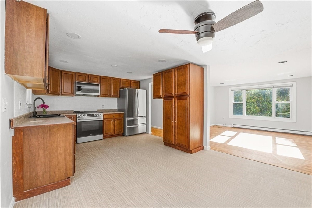 179 Hedges Pond Road Plymouth, MA 02360 - Photo 8 of 18 a kitchen with stainless steel appliances granite countertop a refrigerator a sink a stove a microwave a counter space and cabinets