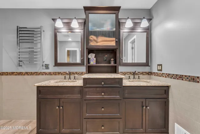 a bathroom with a granite countertop sink a toilet and bathtub
