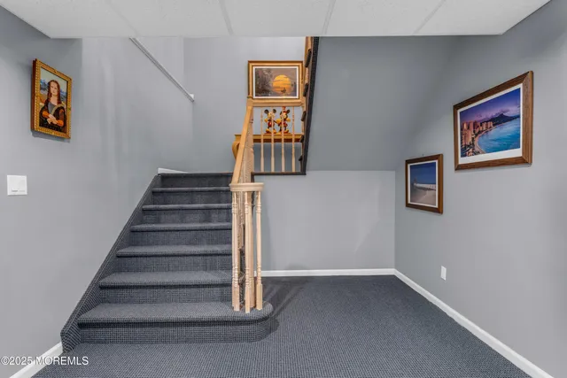 a aerial view of a house next to a big yard and large trees