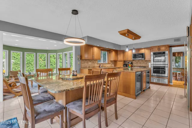 a dining table with chairs and window
