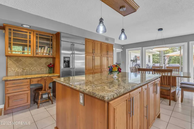 a dining room with furniture a chandelier and wooden floor