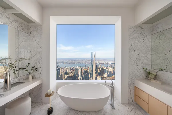 a bathroom with a granite countertop sink and a bathtub
