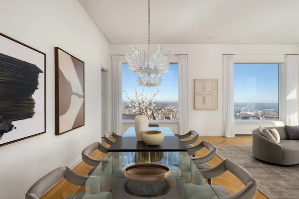 a living room with furniture chandelier and a flat screen tv