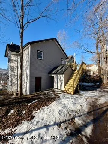 a view of a house with a snow in the yard