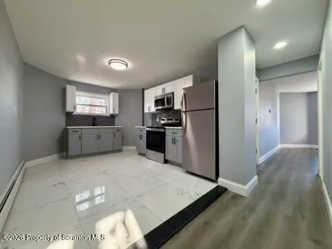 a kitchen with refrigerator and microwave