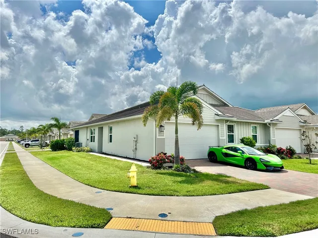 a front view of a house with a garden and plants