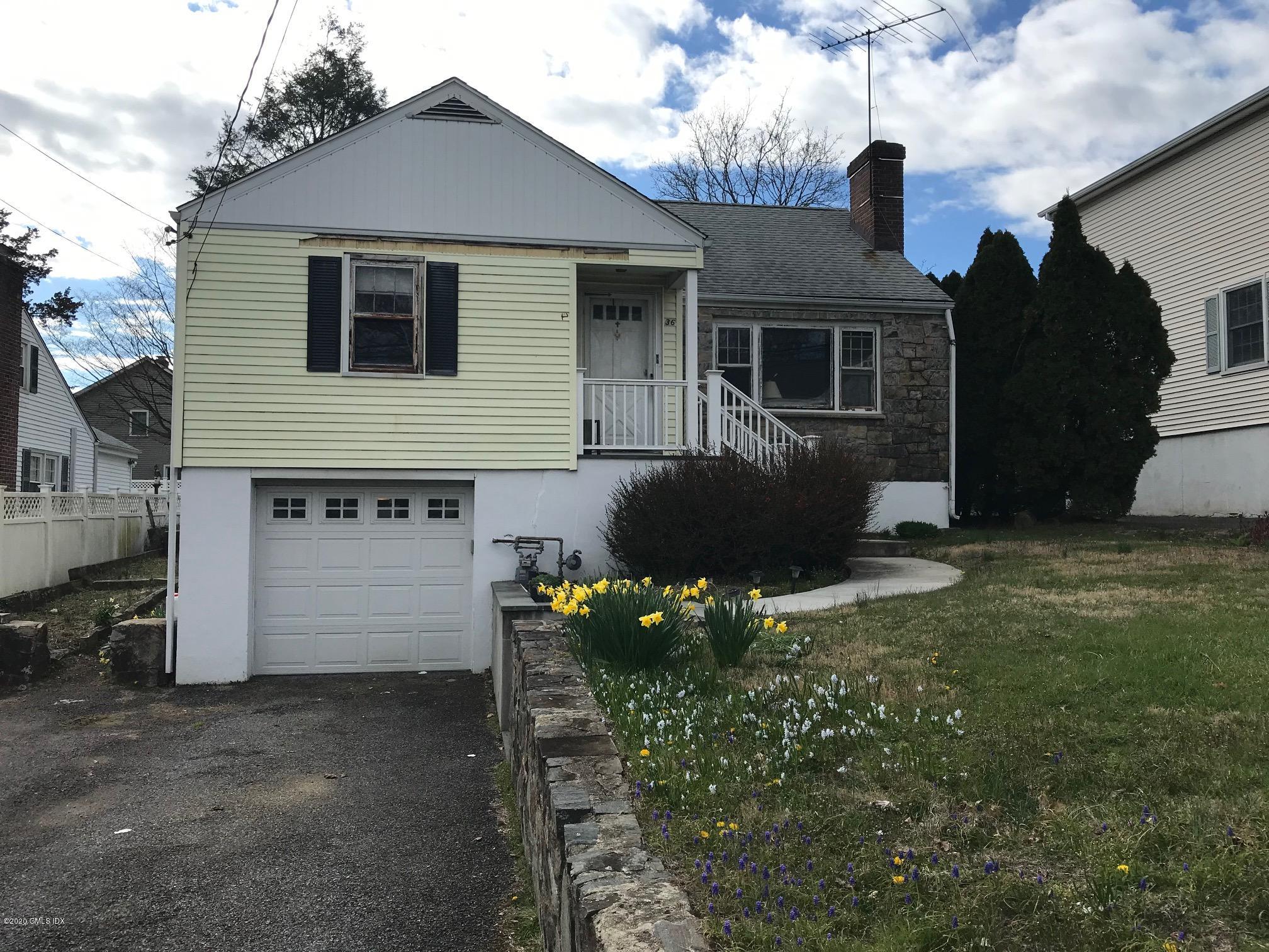 36 Sheep Hill Road Riverside, CT 06878 - Photo 2 of 16 a front view of a house with a yard