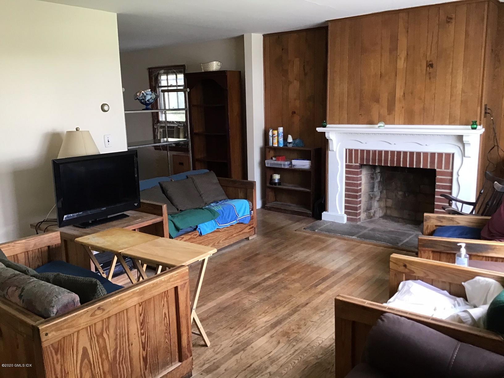 36 Sheep Hill Road Riverside, CT 06878 - Photo 4 of 16 a living room with furniture a fireplace and a flat screen tv