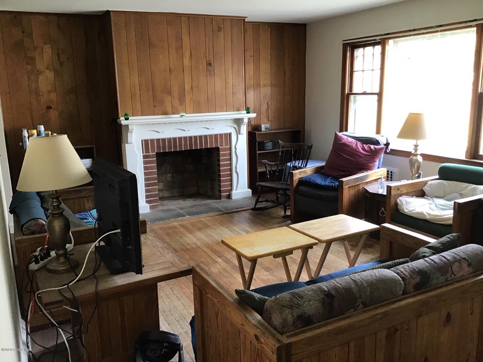 36 Sheep Hill Road Riverside, CT 06878 - Photo 5 of 16 a living room with furniture a window and a fireplace