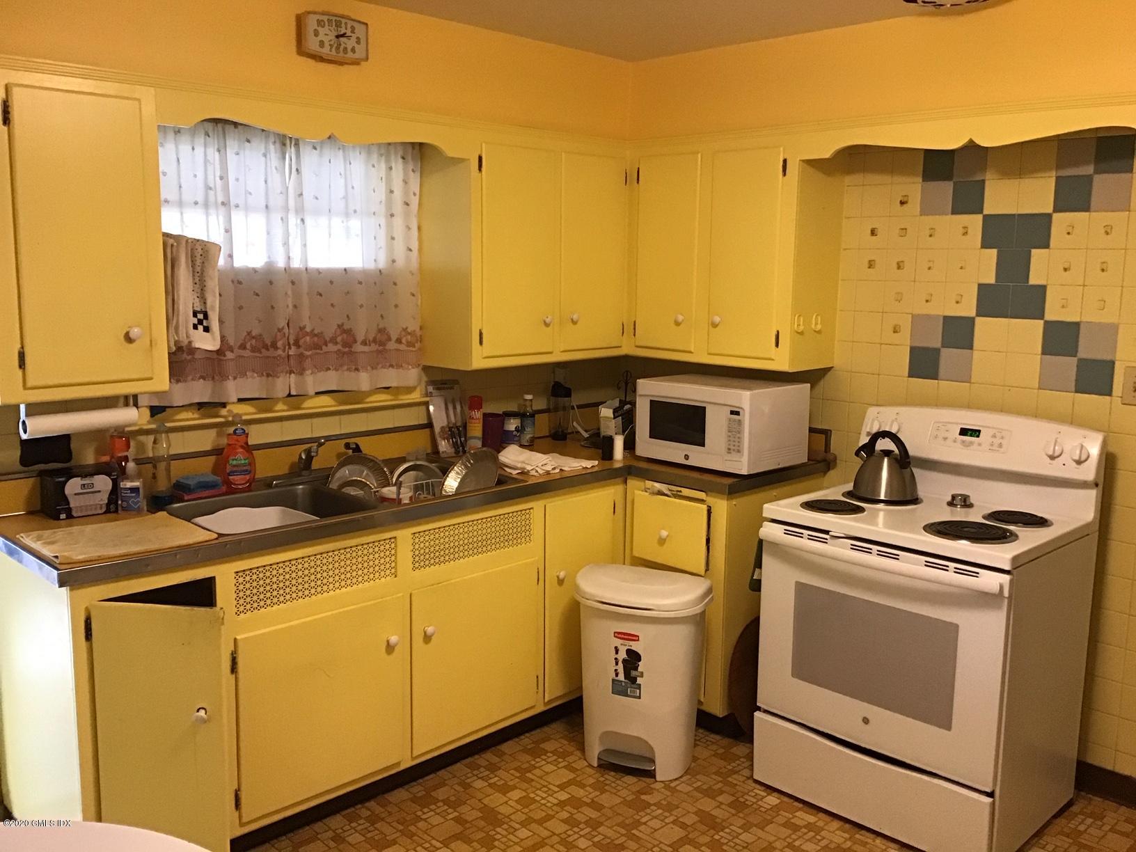 36 Sheep Hill Road Riverside, CT 06878 - Photo 8 of 16 a view of a kitchen with a stove top oven