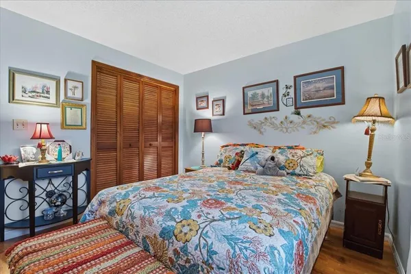 a bedroom with a bed and wooden floor