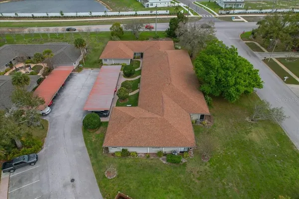 an aerial view of a house with garden space and a lake view
